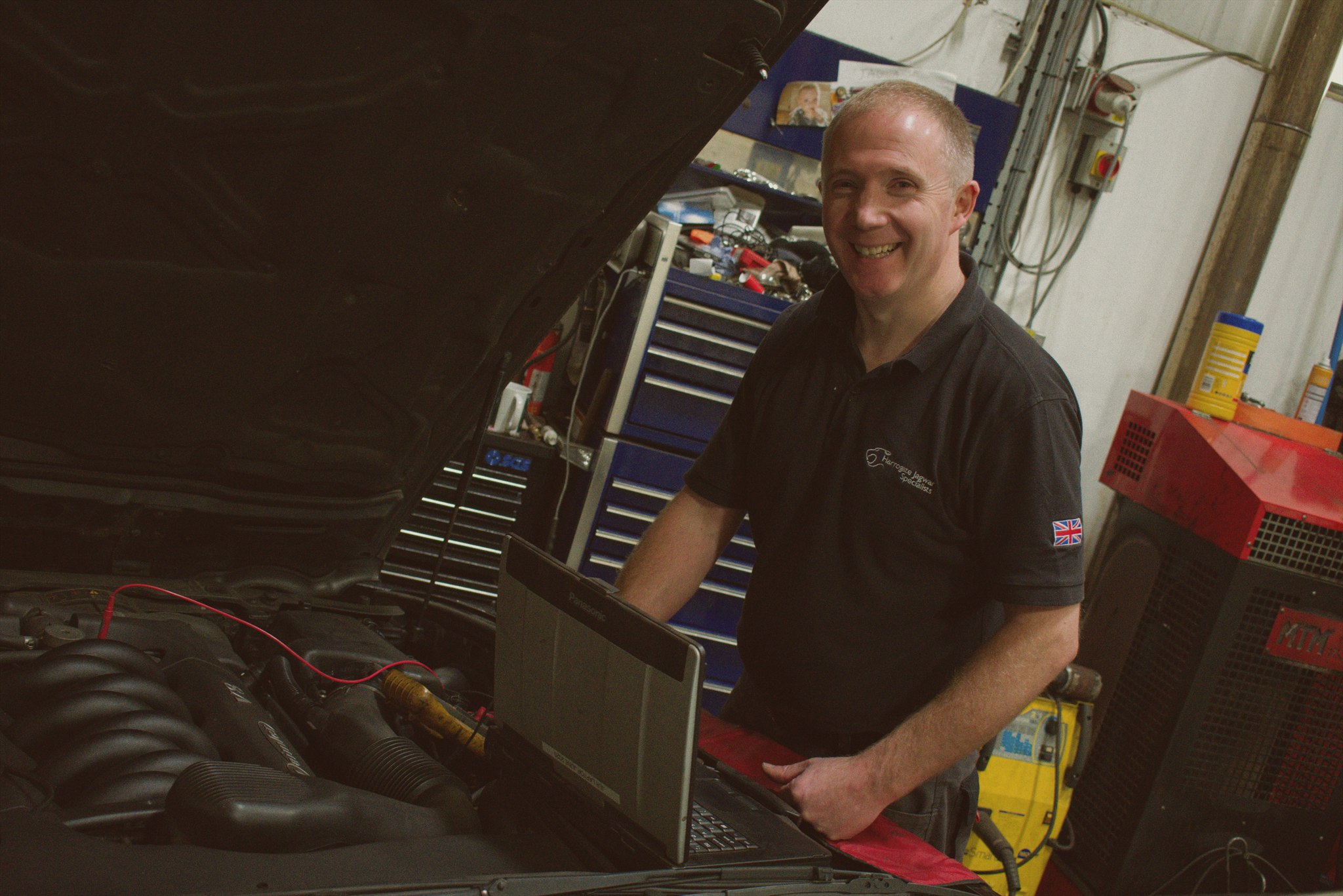 Trevor Montgomery smiling beside a Jaguar at Harrogate Jagwar Specialists